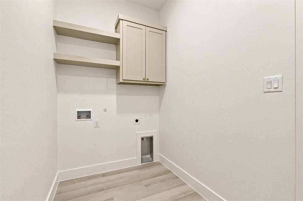 3023 Mallory Drive, Dallas, TX 75216 Laundry area featuring wood-finish flooring, built-in cabinetry, and integrated shelving