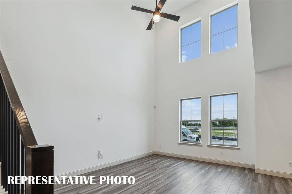 4755 Lunker Street, McKinney, TX 75071 Featuring volume windows in the family room, this beautiful home is filled with natural light. REPRESENTATIVE PHOTO