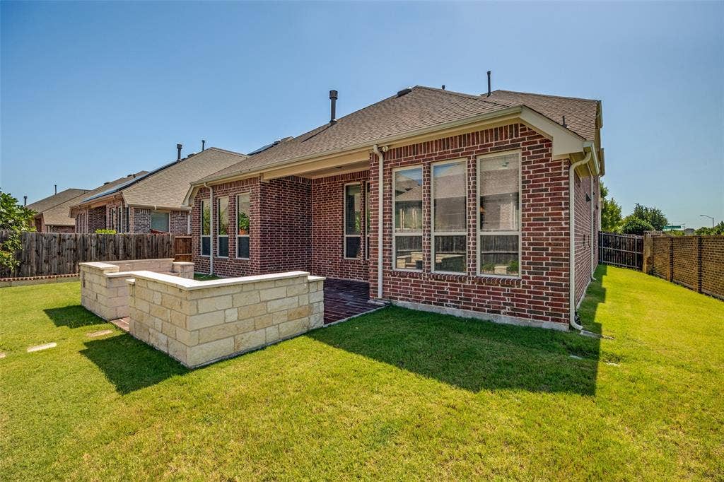 801 Feathering Way, Plano, TX 75074 Brick exterior, large backyard, stone retaining walls, covered patio, multiple windows