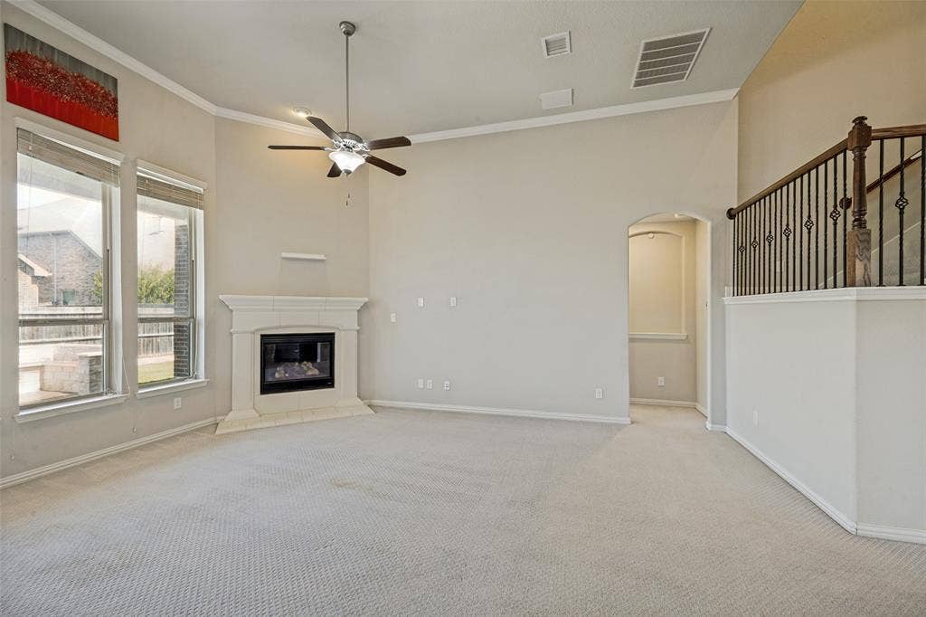 801 Feathering Way, Plano, TX 75074 Spacious room featuring vaulted ceilings, a corner fireplace, and large windows