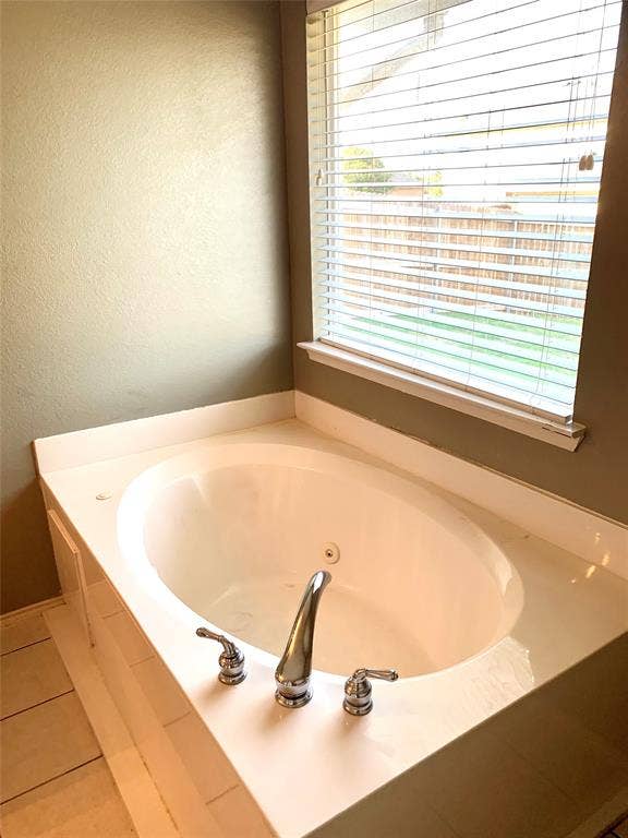 5512 Vineyard Lane, McKinney, TX 75070 Alcove bathtub featuring a white surround, chrome fixtures, and a corner window with horizontal blinds