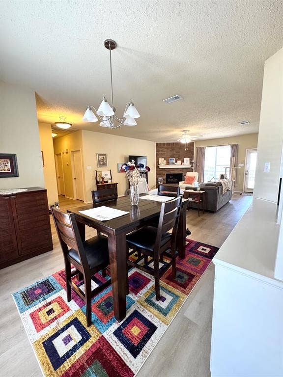 5512 Vineyard Lane, McKinney, TX 75070 Hard-surface flooring throughout, featuring a five-light chandelier in the dining area