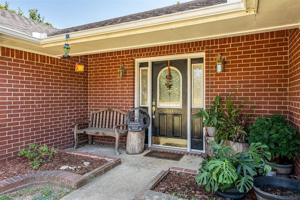 310 Linda Lane, Lindale, TX 75771 Brick exterior, covered entry, and decorative glass entry door with sidelights