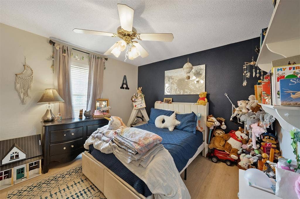 310 Linda Lane, Lindale, TX 75771 Recessed window with blinds, overhead ceiling fan with light fixture, wood-finish flooring, and built-in shelving