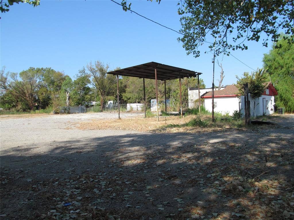 2822 Childs Street, Dallas, TX 75203 Detached structure with white siding and red trim, concrete foundation, and a metal carport structure