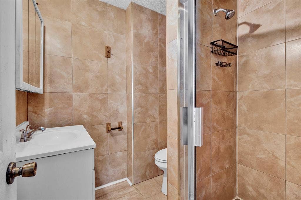 3572 State Highway 110 N, Tyler, TX 75704 Vanity with integrated sink, chrome faucet, and mirrored medicine cabinet
