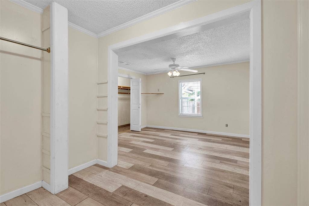 3572 State Highway 110 N, Tyler, TX 75704 Room with wood-finish flooring, a ceiling fan, and a window with horizontal blinds