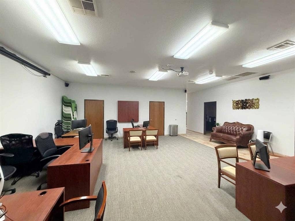 4512 Legacy Drive, #100, Plano, TX 75024 Spacious interior featuring a combination of carpeted and tiled flooring, multiple overhead fluorescent light fixtures, and a ceiling-mounted projector