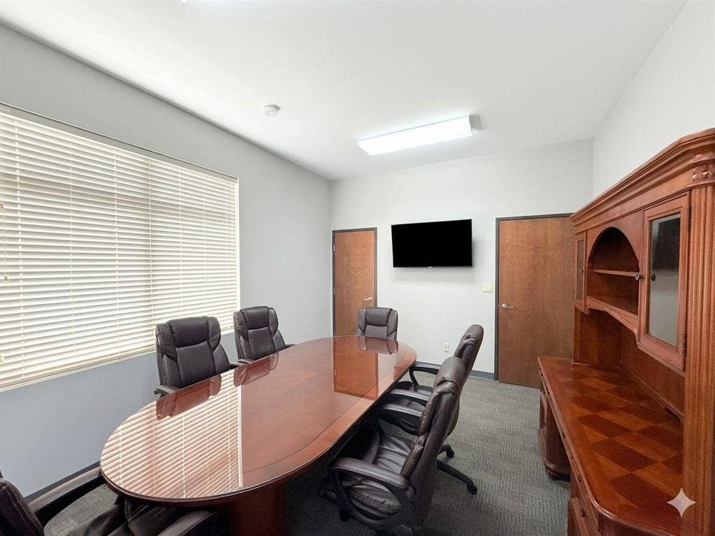 4512 Legacy Drive, #100, Plano, TX 75024 Conference room with light gray walls, wood-finish doors, wall-mounted display, and carpeted flooring
