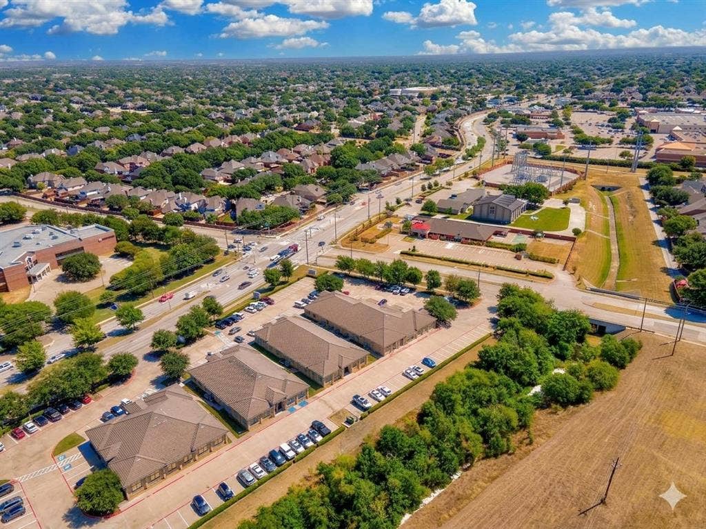 4512 Legacy Drive, #100, Plano, TX 75024 Expansive aerial view of a suburban area featuring residential neighborhoods, commercial buildings, and mature landscaping
