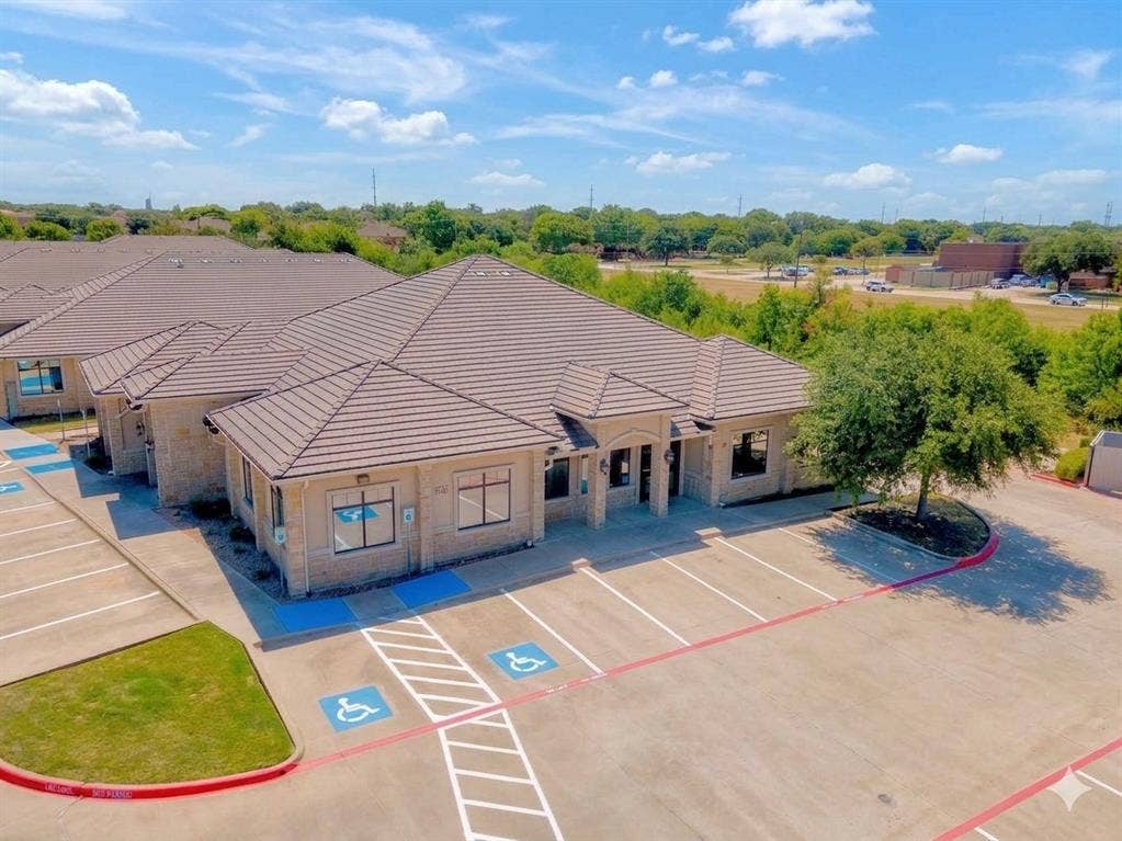 4512 Legacy Drive, #100, Plano, TX 75024 Tile roof, stone exterior, multiple building entrances, dedicated parking, and mature landscaping