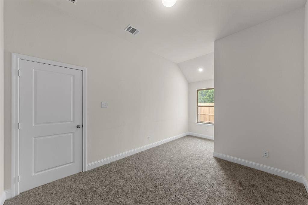 Neutral wall finishes with a single window, recessed lighting, and carpet flooring