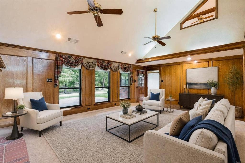 26 Lago Vista W, Wylie, TX 75098 Virtually Staged - Vaulted ceiling with exposed wood beams, ceiling fans, wood paneling, recessed lighting, and large windows