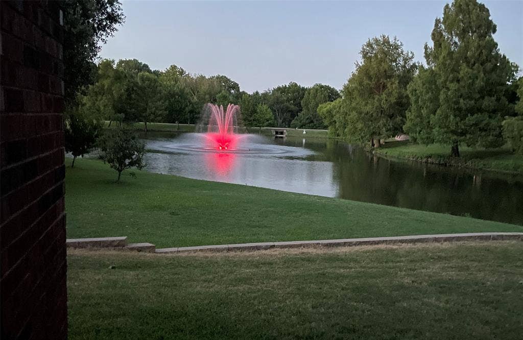 26 Lago Vista W, Wylie, TX 75098 Fountain is lit up at night with varying colors.