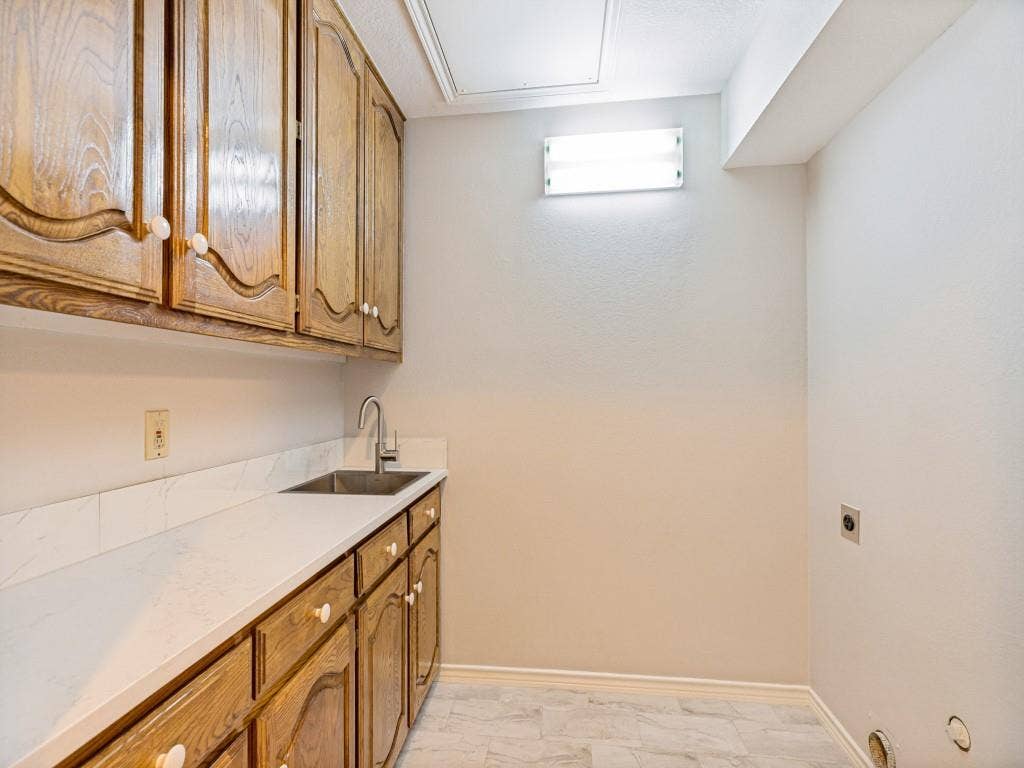 26 Lago Vista W, Wylie, TX 75098 Extensive cabinetry, quartz counters, stainless steel sink with gooseneck faucet, light-toned tile flooring