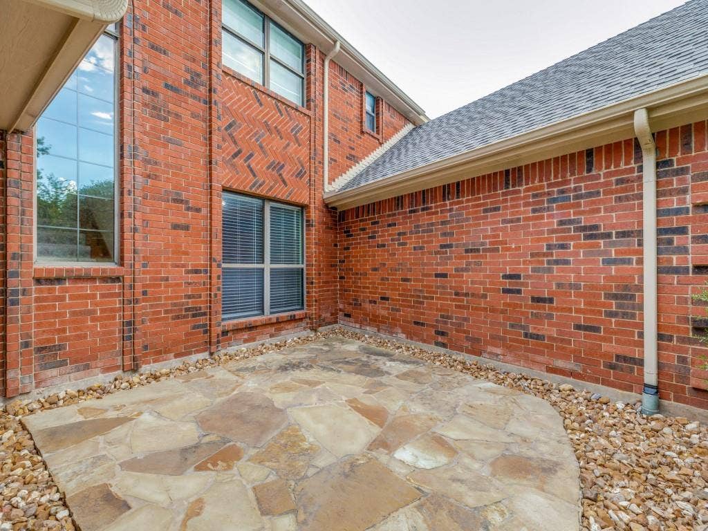 26 Lago Vista W, Wylie, TX 75098 Flagstone patio to the right of entry