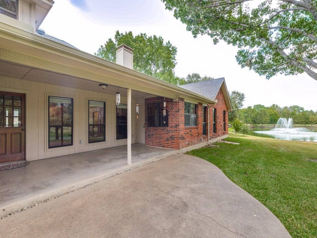 26 Lago Vista W, Wylie, TX 75098 Back porch with expansive view of the back yard with mature trees overlooking the pond