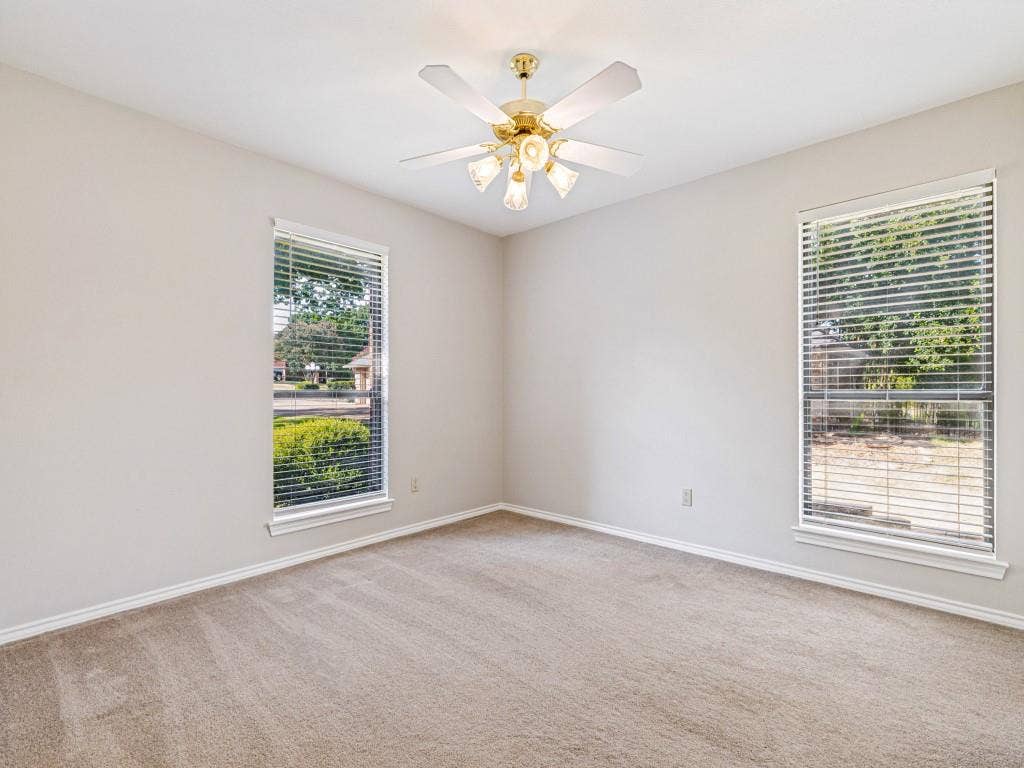 26 Lago Vista W, Wylie, TX 75098 Neutral wall finishes, carpeting, and a ceiling fan with integrated lighting