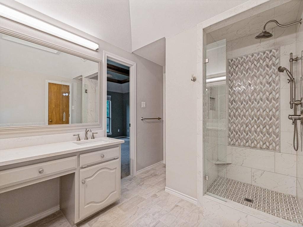 26 Lago Vista W, Wylie, TX 75098 Walk-in shower with chevron mosaic tile accent, glass enclosure, and tiled flooring