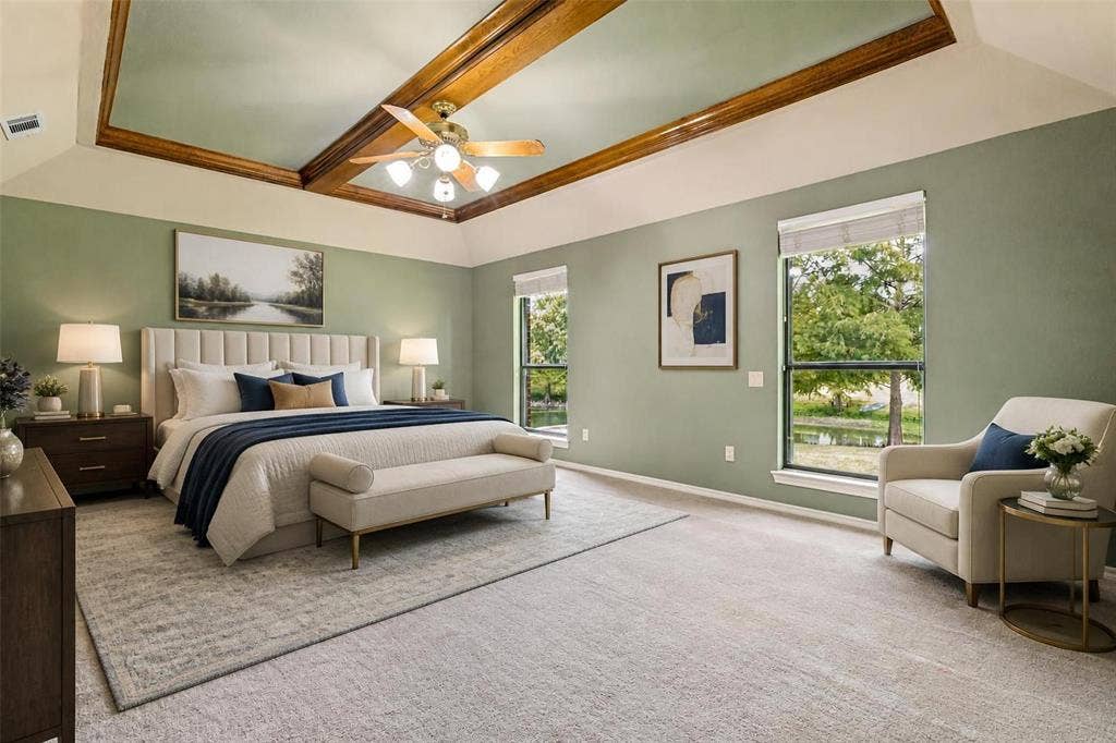 26 Lago Vista W, Wylie, TX 75098 Virtually Staged - Tray ceiling with wood-finish trim, ceiling fan with integrated lighting, two large windows, and wall-to-wall carpeting