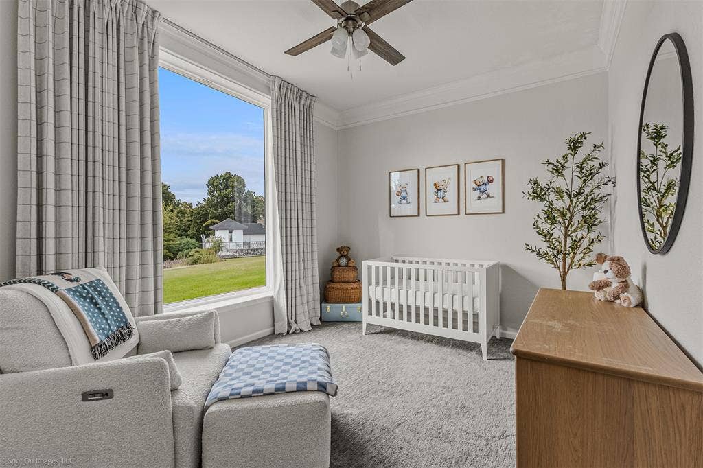 28 Victoria Drive, Rowlett, TX 75088 Large window with expansive outdoor scenery, crown molding, ceiling fan, and carpeted flooring