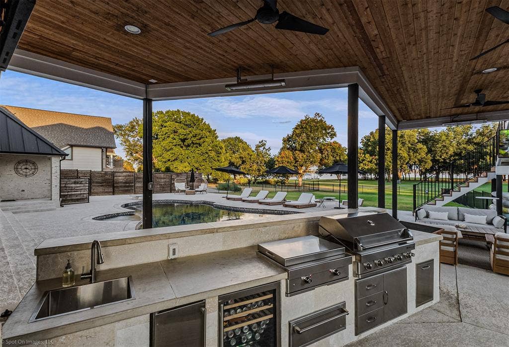 28 Victoria Drive, Rowlett, TX 75088 Covered outdoor kitchen featuring a built-in grill, integrated sink, and wine refrigerator