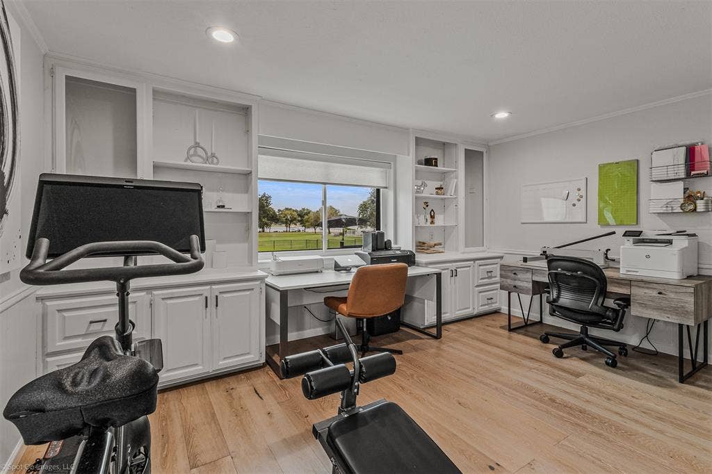 28 Victoria Drive, Rowlett, TX 75088 Wood-finish flooring, built-in white cabinetry, recessed lighting, and a large window overlooking green space