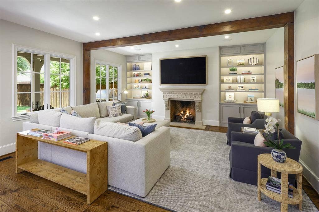 3637 Haynie Avenue, University Park, TX 75205 Living room with gas fireplace, wood beamed ceiling, and built-in cabinetry and custom built ins