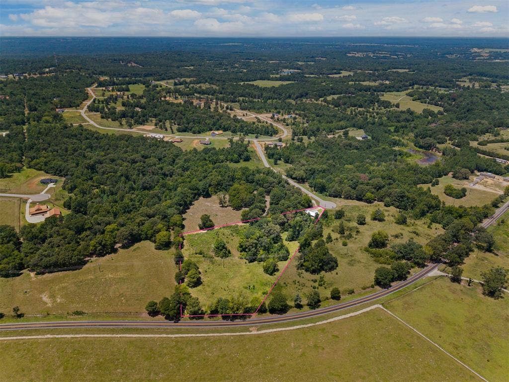 16713 Creek Bottom Court, Winona, TX 75792 Expansive lot featuring mature trees, open grassland, and direct road frontage