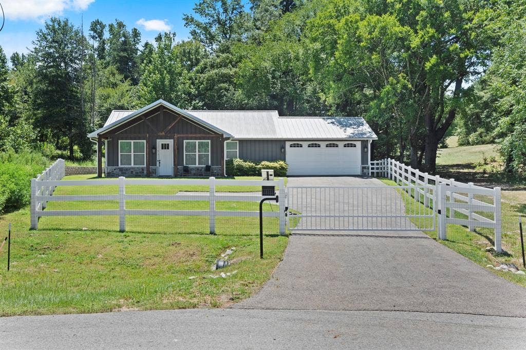 16713 Creek Bottom Court, Winona, TX 75792 Gated asphalt driveway with a white three-rail fence