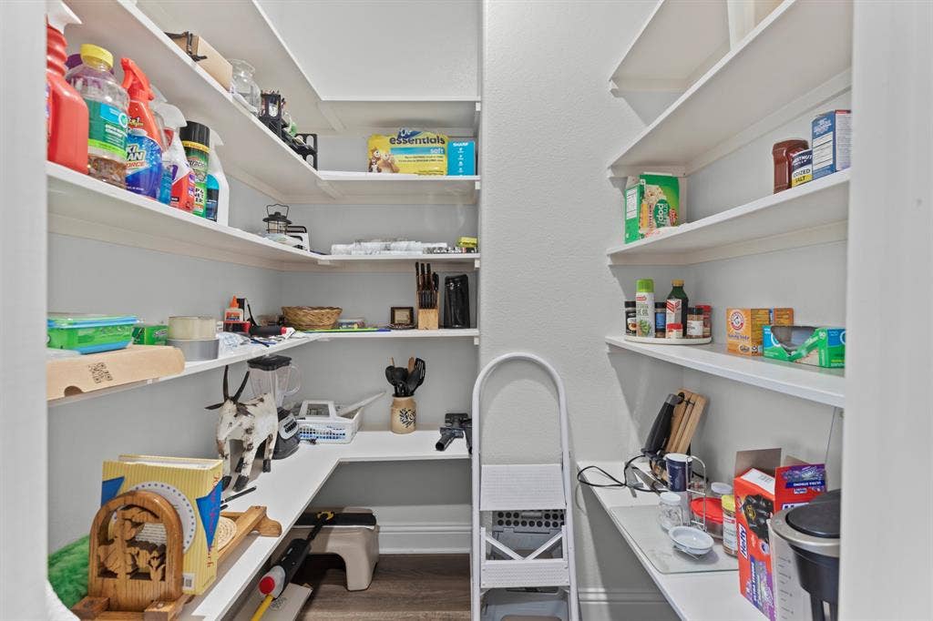 16713 Creek Bottom Court, Winona, TX 75792 Walk-in pantry with extensive built-in shelving, white finish, and wood-finish flooring