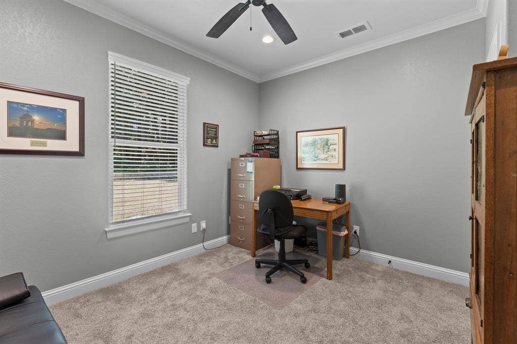 16713 Creek Bottom Court, Winona, TX 75792 Recessed ceiling fan, crown molding, white trim, window with blinds, and light gray wall paint