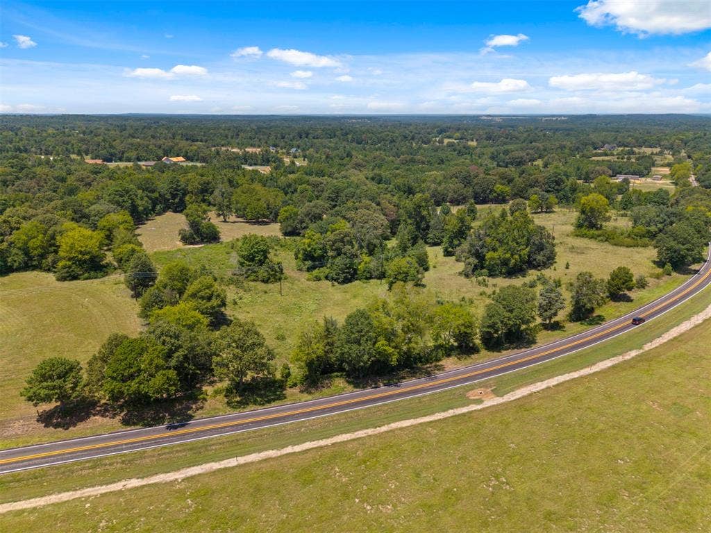 16713 Creek Bottom Court, Winona, TX 75792 Expansive acreage featuring a paved roadway and surrounding woodlands