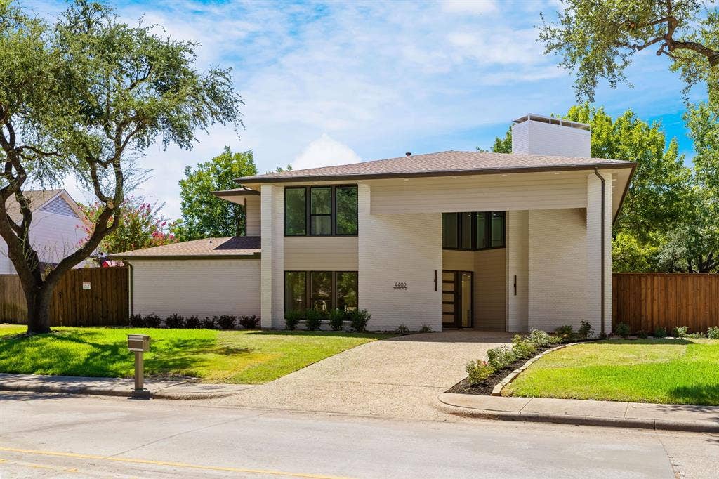 4402 Briargrove Lane, Dallas, TX 75287 4402 Briargrove-Transitional modern architecture with white brick and warm wood accents.
