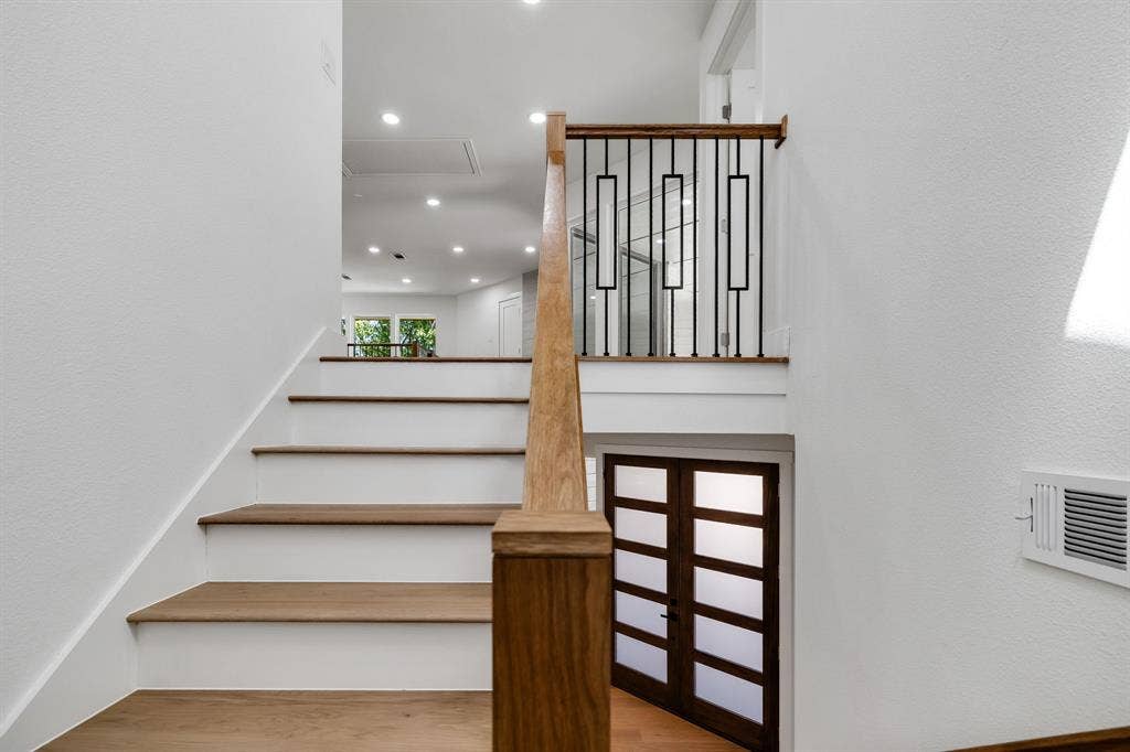 4402 Briargrove Lane, Dallas, TX 75287 4402 Briargrove-Hardwood stair treads with white risers and a wood handrail