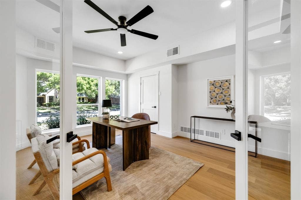 4402 Briargrove Lane, Dallas, TX 75287 4402 Briargrove-Recessed lighting, wide-plank white oak flooring, glass French doors, a modern ceiling fan, and expansive windows.