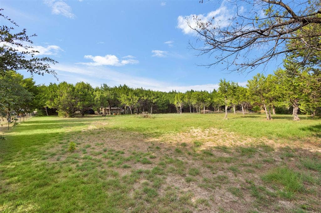 Expansive lot featuring mature trees and open green spaces