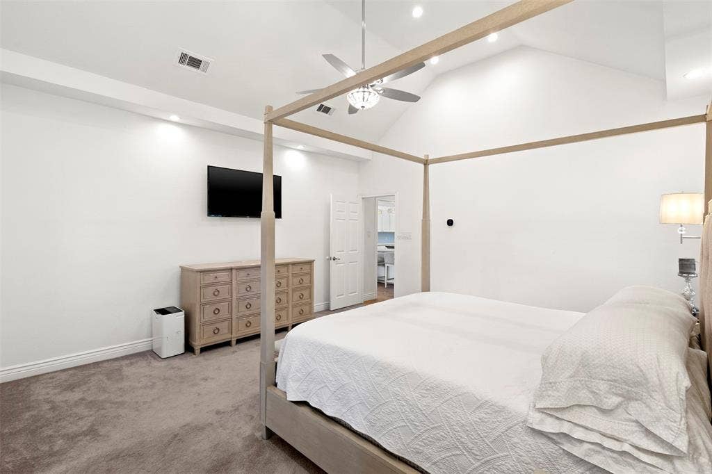 Vaulted ceilings, recessed lighting, ceiling fan, and carpeted flooring