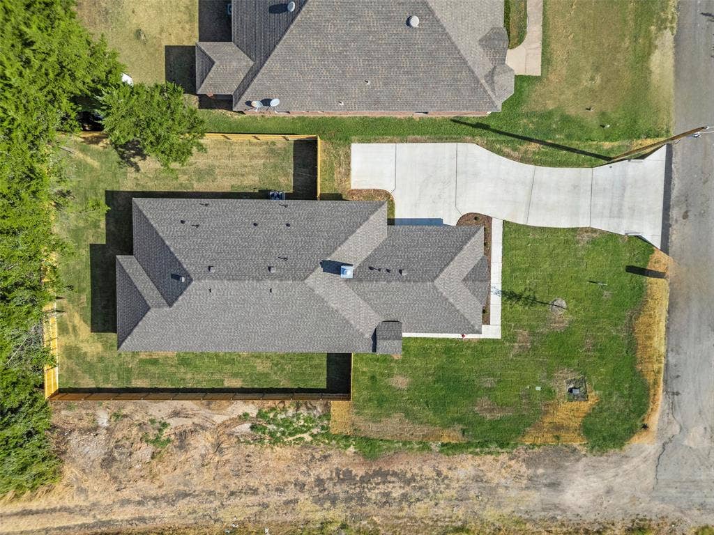 111 WATERCREST Lane, Glenn Heights, TX 75154 Residential property featuring a gray shingle roof, concrete driveway, and a partially fenced backyard