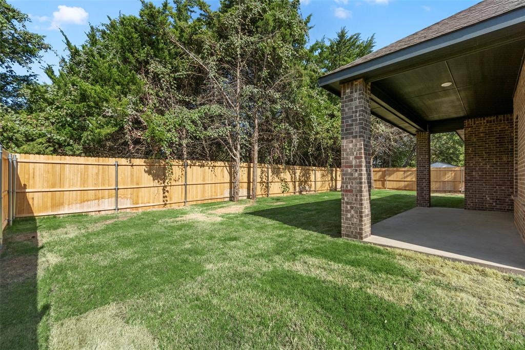 111 WATERCREST Lane, Glenn Heights, TX 75154 Expansive grassy yard with wood fencing and mature trees