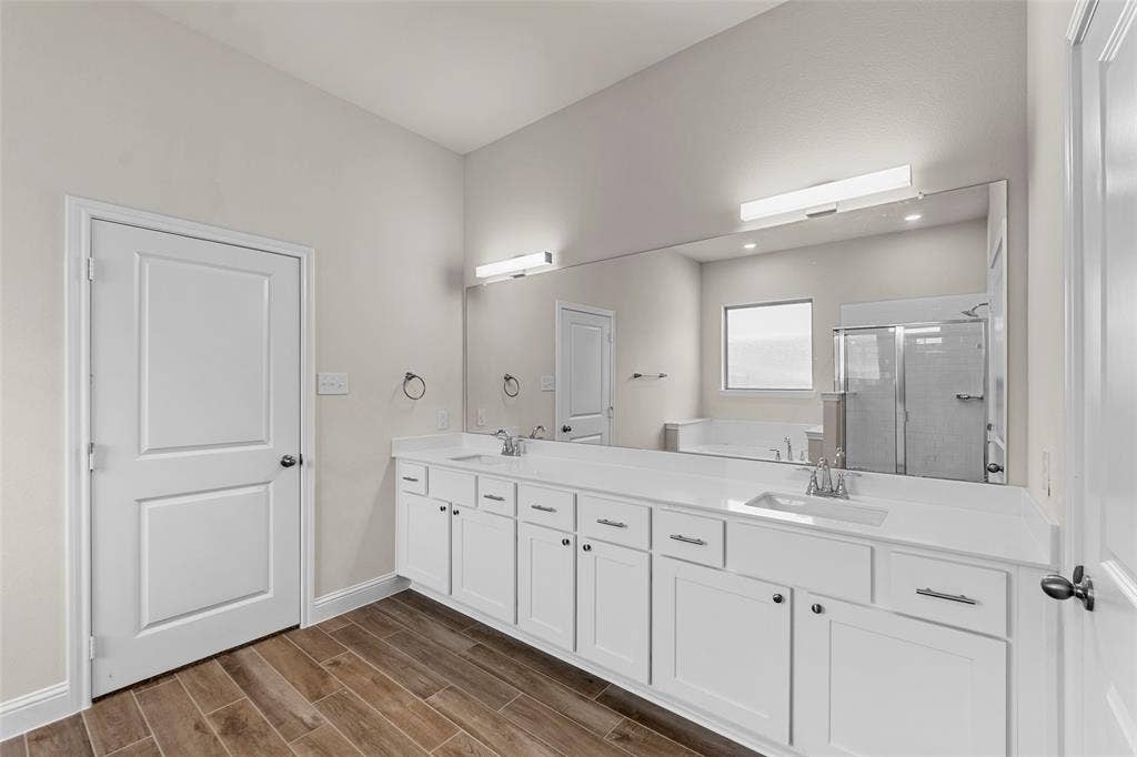 111 WATERCREST Lane, Glenn Heights, TX 75154 Dual vanity with white cabinetry, integrated sinks, and polished chrome fixtures
