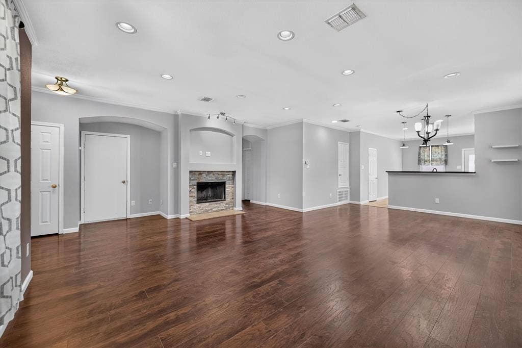 6513 Cartier Court, McKinney, TX 75072 Wood-finish flooring throughout, recessed lighting, and a stone-faced fireplace