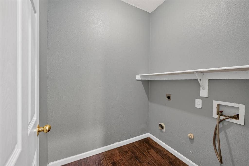 6513 Cartier Court, McKinney, TX 75072 Utility area featuring wood-finish flooring, a white paneled door, and a built-in wall shelf