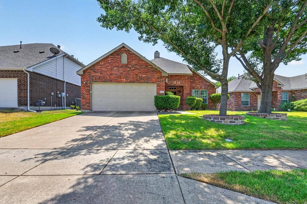 6513 Cartier Court, McKinney, TX 75072 Brick exterior, attached garage, concrete driveway, mature trees, landscaped front yard