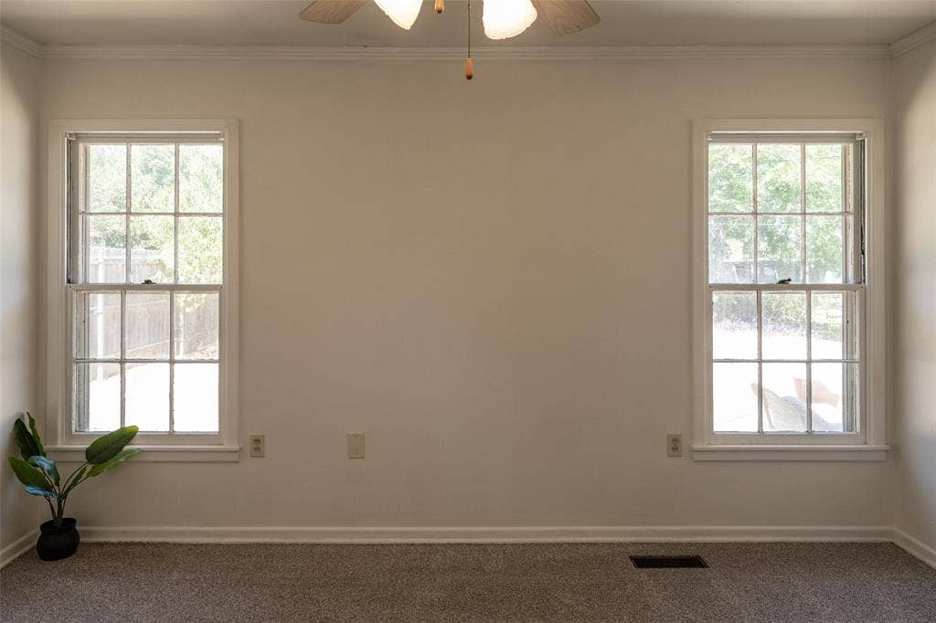 3807 Huaco Lane, Waco, TX 76710 Dual pane windows, crown molding, and a ceiling fan with integrated lighting