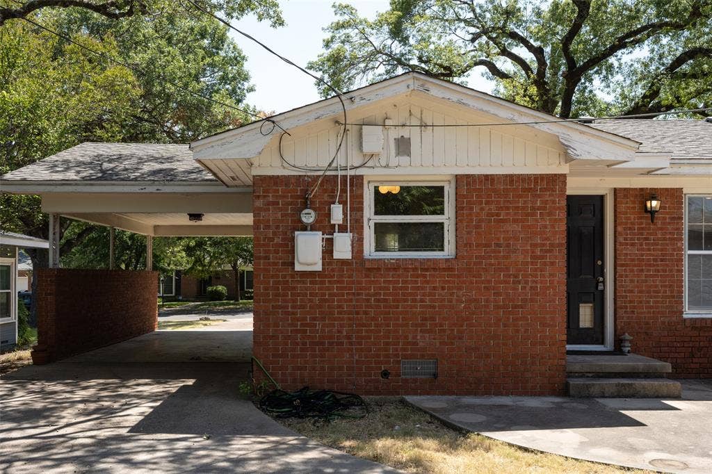 3807 Huaco Lane, Waco, TX 76710 Brick exterior, covered carport, concrete driveway, front entry door, exterior lighting fixture