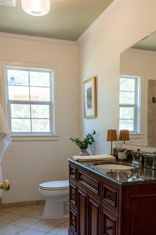 3807 Huaco Lane, Waco, TX 76710 Rich wood-finish vanity with a dark countertop and integrated sink