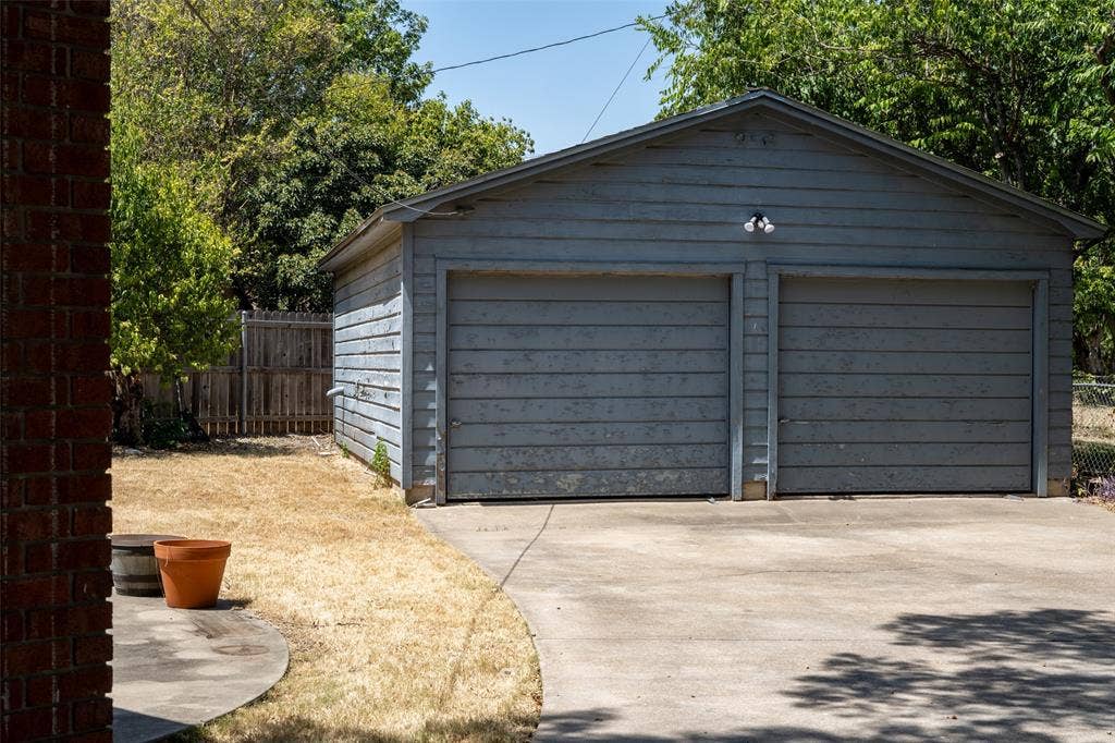 3807 Huaco Lane, Waco, TX 76710 Detached two-car garage with horizontal siding, two individual garage doors, and a concrete driveway