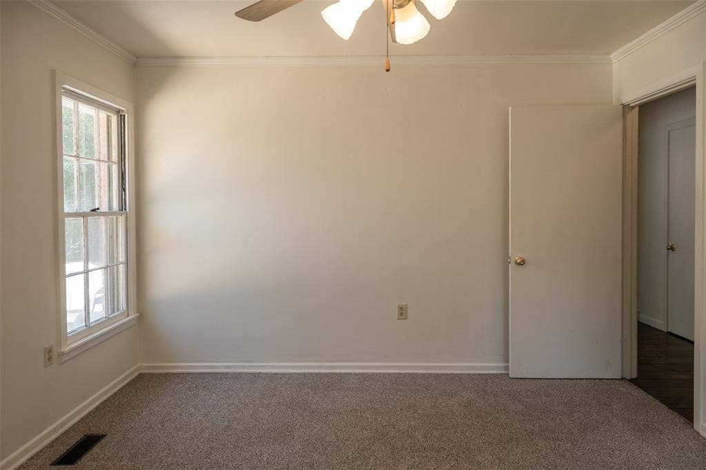 3807 Huaco Lane, Waco, TX 76710 Wall-to-wall carpeting, crown molding, white trim, and a ceiling fan with integrated lighting