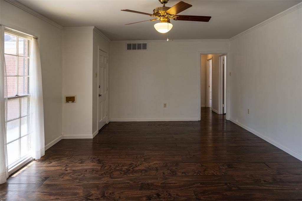 3807 Huaco Lane, Waco, TX 76710 Wood-finish flooring throughout, white painted walls, and a ceiling fan with integrated lighting
